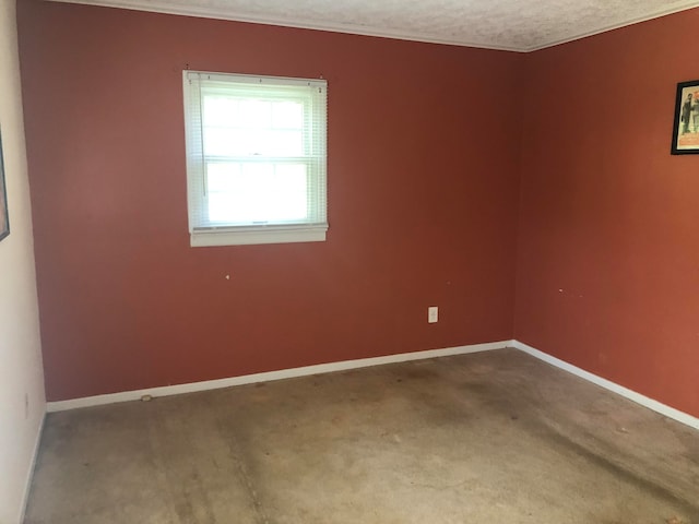 unfurnished room featuring baseboards and a textured ceiling