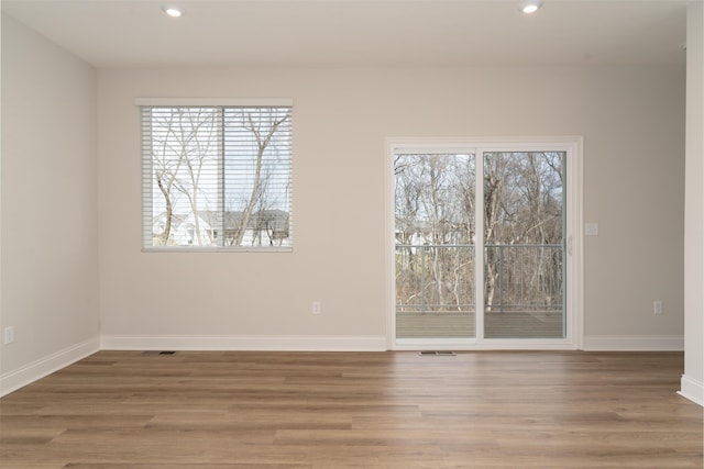 unfurnished room with hardwood / wood-style floors