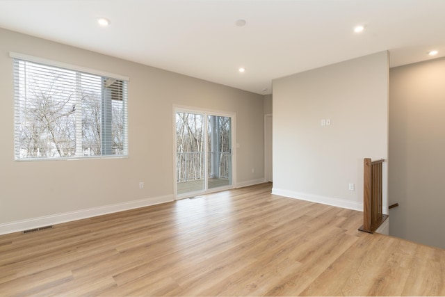 spare room featuring light hardwood / wood-style flooring