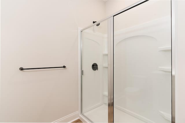 bathroom with a shower with shower door