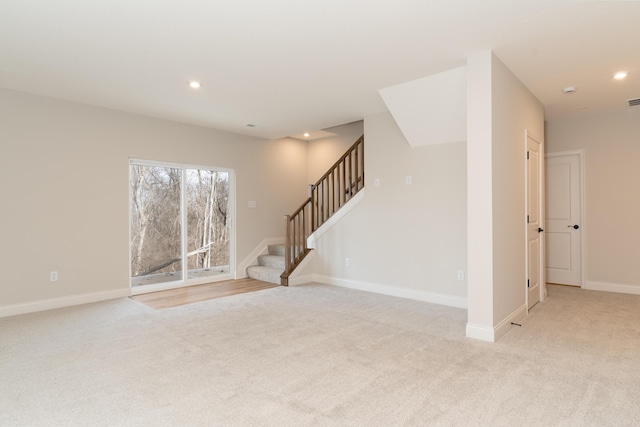 unfurnished living room featuring light carpet