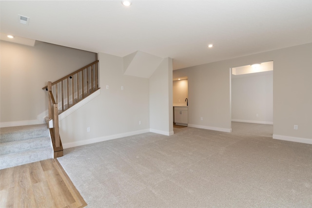 interior space with light carpet and sink