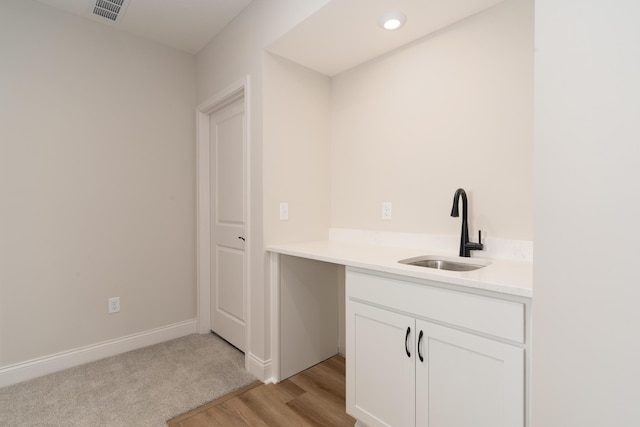 bathroom featuring sink and hardwood / wood-style flooring