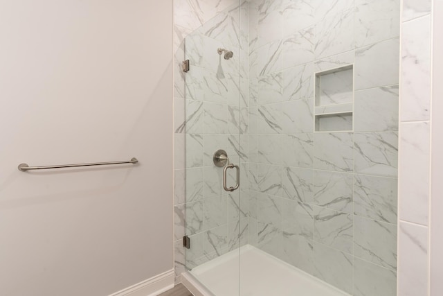 bathroom featuring a shower with shower door