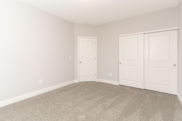 unfurnished bedroom with carpet floors and a closet