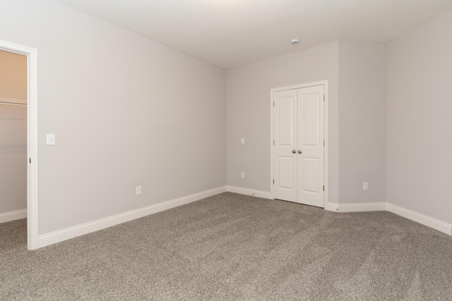 unfurnished bedroom with carpet floors and a closet