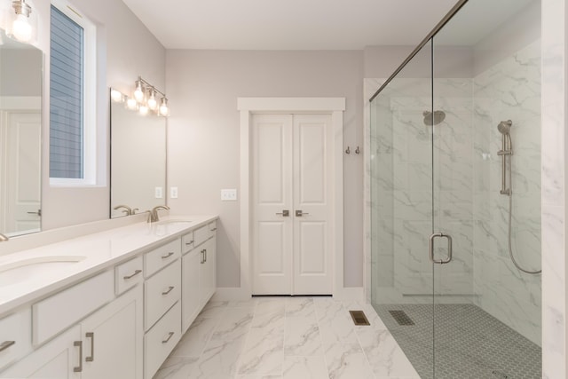 bathroom featuring vanity and a shower with shower door