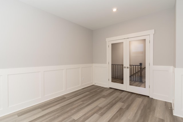 spare room with french doors and hardwood / wood-style flooring