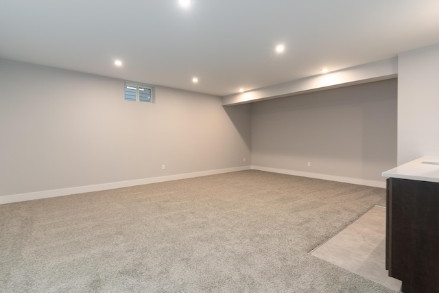 basement featuring light carpet