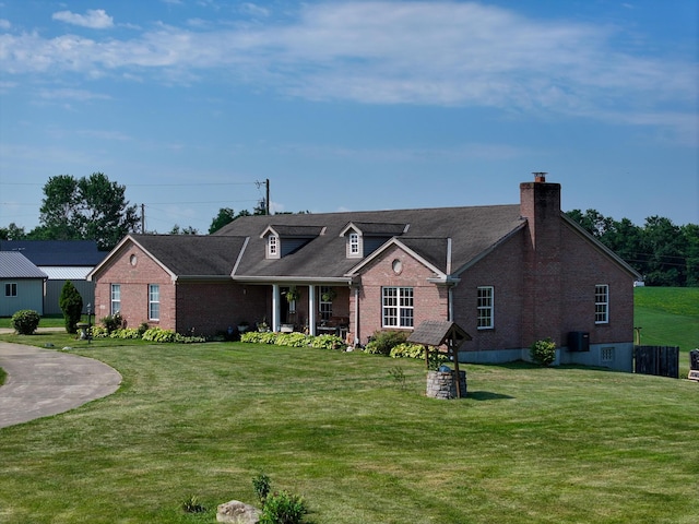 view of front of home with a front yard and central AC unit