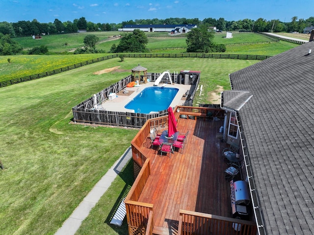 view of pool featuring a water slide and a rural view