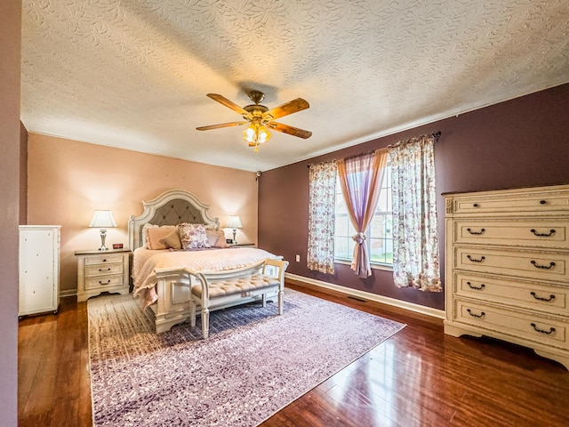 bedroom with dark hardwood / wood-style flooring, a textured ceiling, and ceiling fan