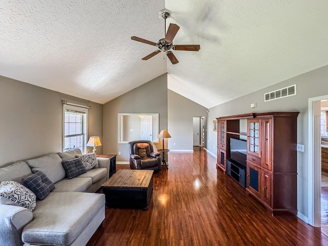 living room with dark hardwood / wood-style flooring, ceiling fan, lofted ceiling, and a textured ceiling