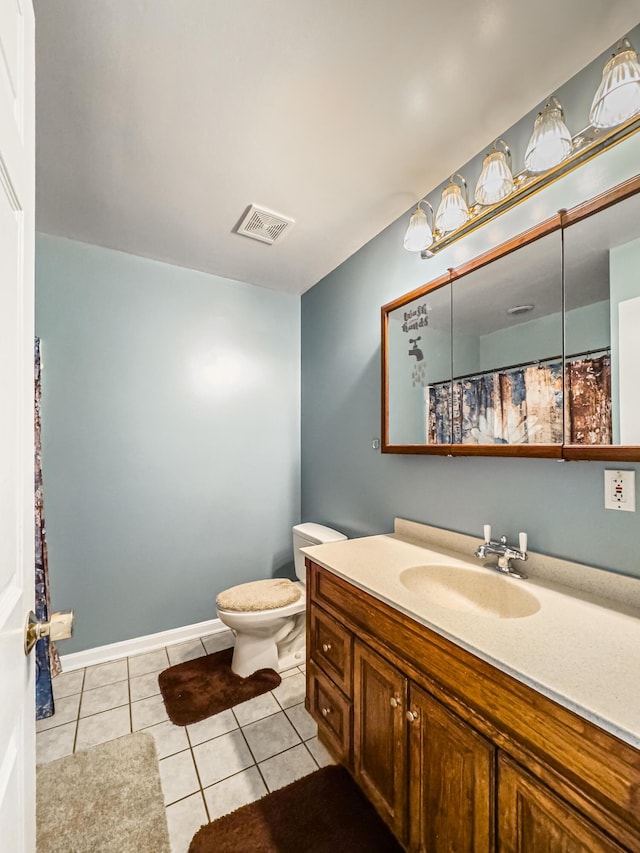 bathroom with tile patterned floors, toilet, and vanity