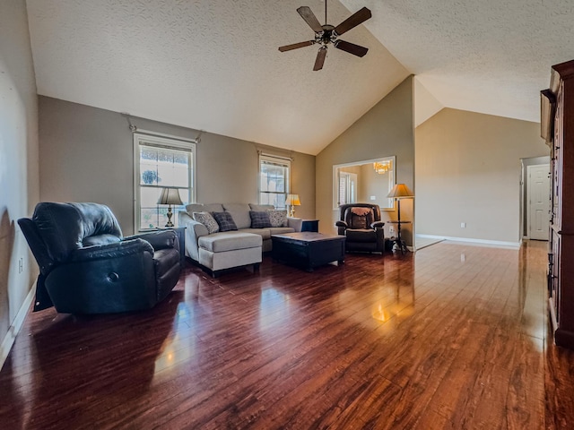 living room with ceiling fan, lofted ceiling, dark hardwood / wood-style flooring, and a textured ceiling