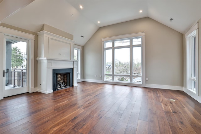 unfurnished living room featuring lofted ceiling and dark hardwood / wood-style floors