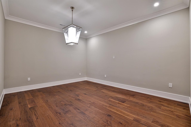 empty room with crown molding and dark hardwood / wood-style floors