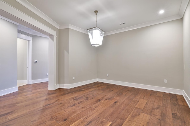 spare room with crown molding and hardwood / wood-style floors