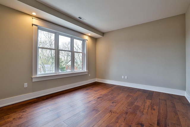 unfurnished room featuring dark wood-type flooring