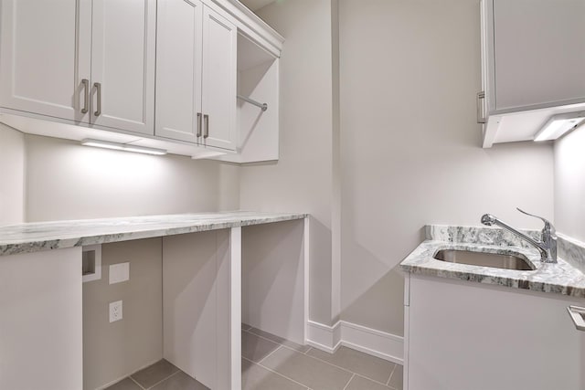 washroom featuring washer hookup, cabinets, light tile patterned flooring, and sink