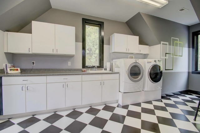 washroom featuring cabinets, sink, and independent washer and dryer