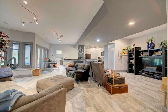 living room featuring light wood-type flooring and track lighting