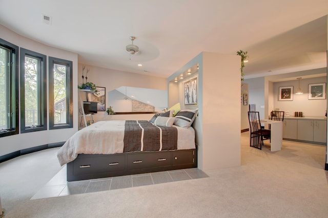 bedroom featuring light carpet and ceiling fan