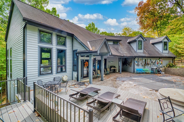 rear view of property with a wooden deck