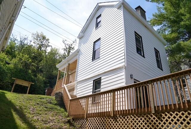 back of property featuring a wooden deck