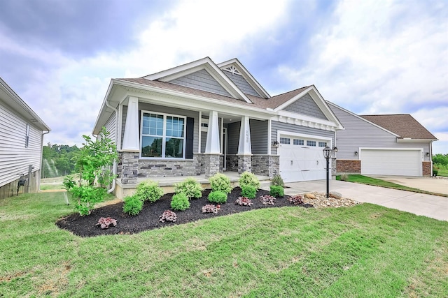 craftsman-style home featuring a porch, a garage, and a front lawn