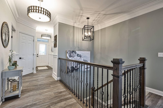 hallway with hardwood / wood-style flooring and ornamental molding