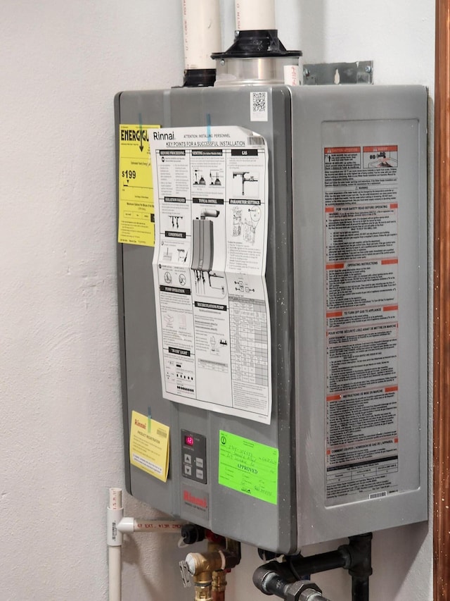 utility room featuring water heater