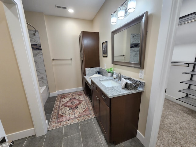 bathroom with baseboards, visible vents, tub / shower combination, and vanity