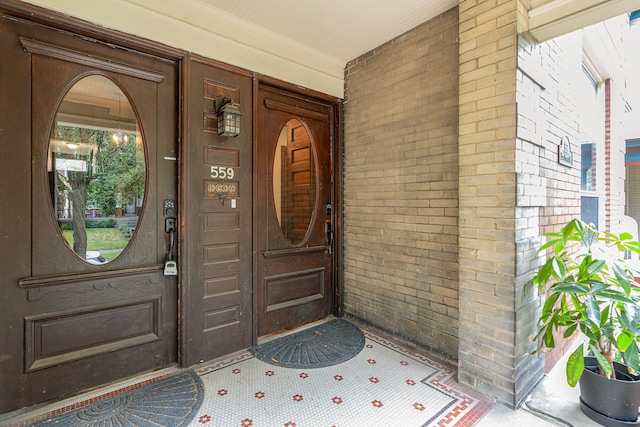 view of exterior entry with covered porch