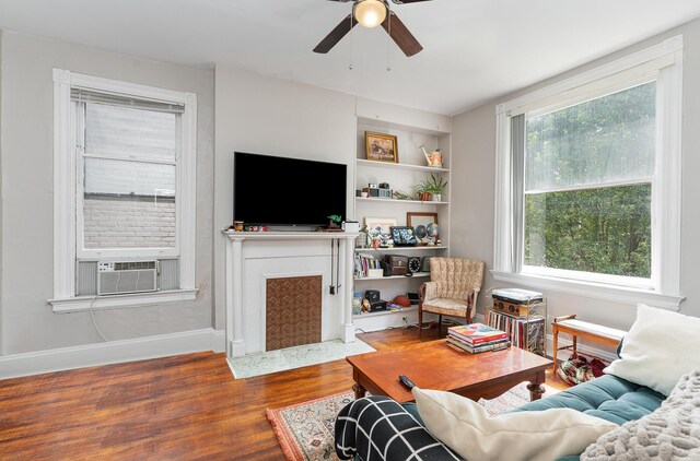 living room featuring hardwood / wood-style flooring, cooling unit, and ceiling fan