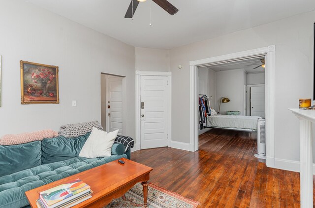 living room featuring hardwood / wood-style flooring and ceiling fan