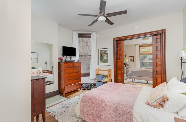 bedroom featuring light wood-type flooring and ceiling fan