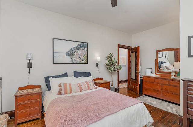 bedroom with dark wood-type flooring and ceiling fan