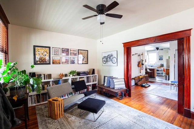 living room with hardwood / wood-style flooring and ceiling fan