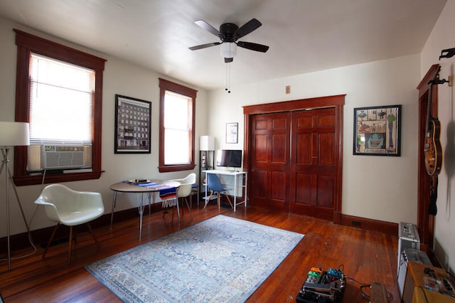 interior space featuring dark hardwood / wood-style floors, cooling unit, and ceiling fan