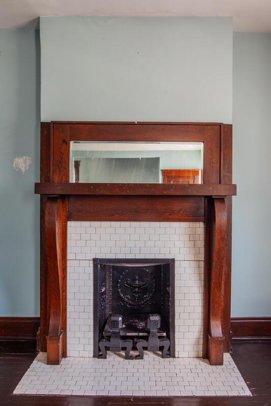 interior details featuring a tile fireplace and hardwood / wood-style flooring