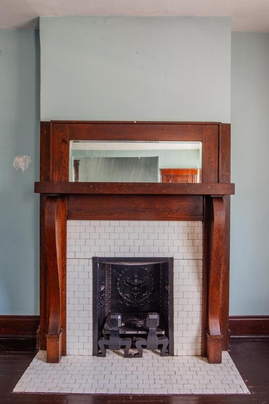 details with a fireplace with flush hearth, baseboards, and wood finished floors