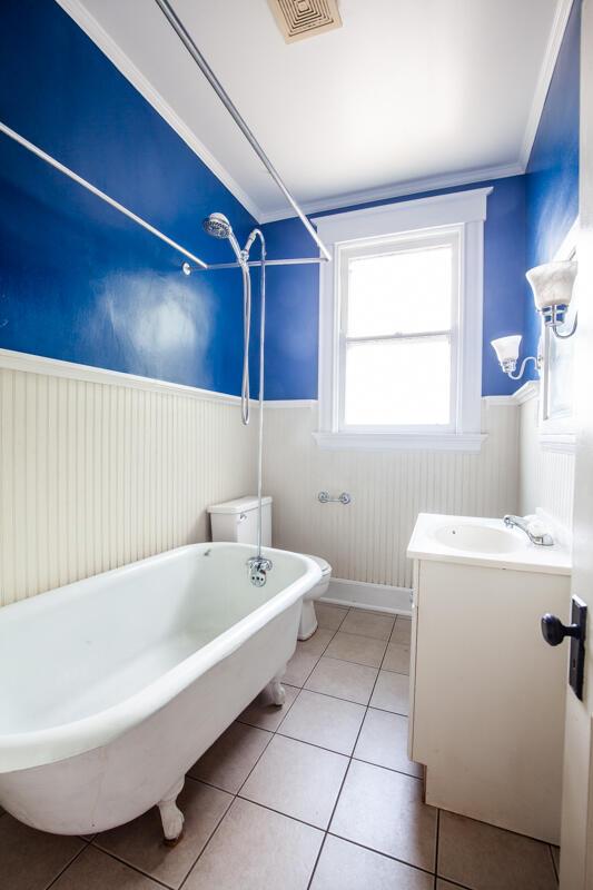 bathroom with ornamental molding, vanity, tile patterned floors, and toilet