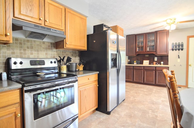 kitchen with backsplash, a textured ceiling, and appliances with stainless steel finishes