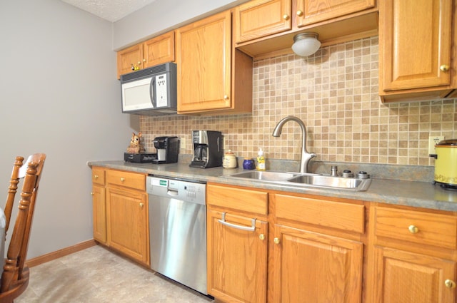 kitchen featuring dishwasher, sink, backsplash, and a textured ceiling