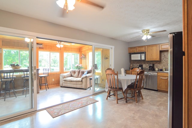 dining room with ceiling fan and a textured ceiling