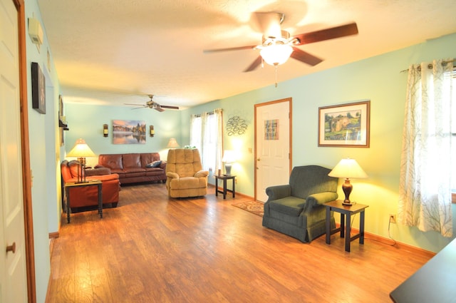 living room with hardwood / wood-style flooring, a healthy amount of sunlight, and ceiling fan