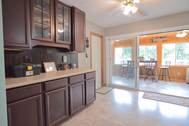 kitchen featuring ceiling fan and dark brown cabinetry