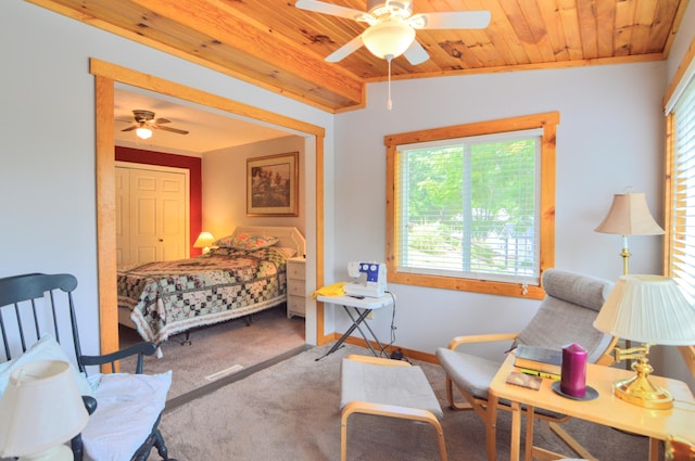 bedroom featuring wooden ceiling, ornamental molding, a closet, ceiling fan, and carpet