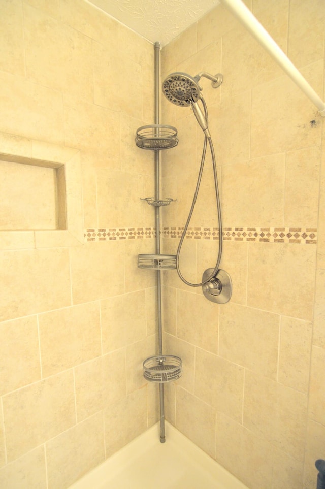 bathroom with tiled shower